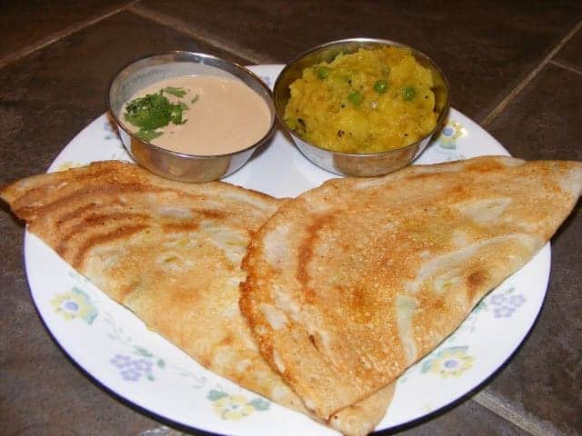 Masala dosa  with peanut chutney in a white plate