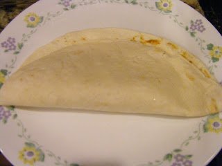 Folding tortilla horizontally.
