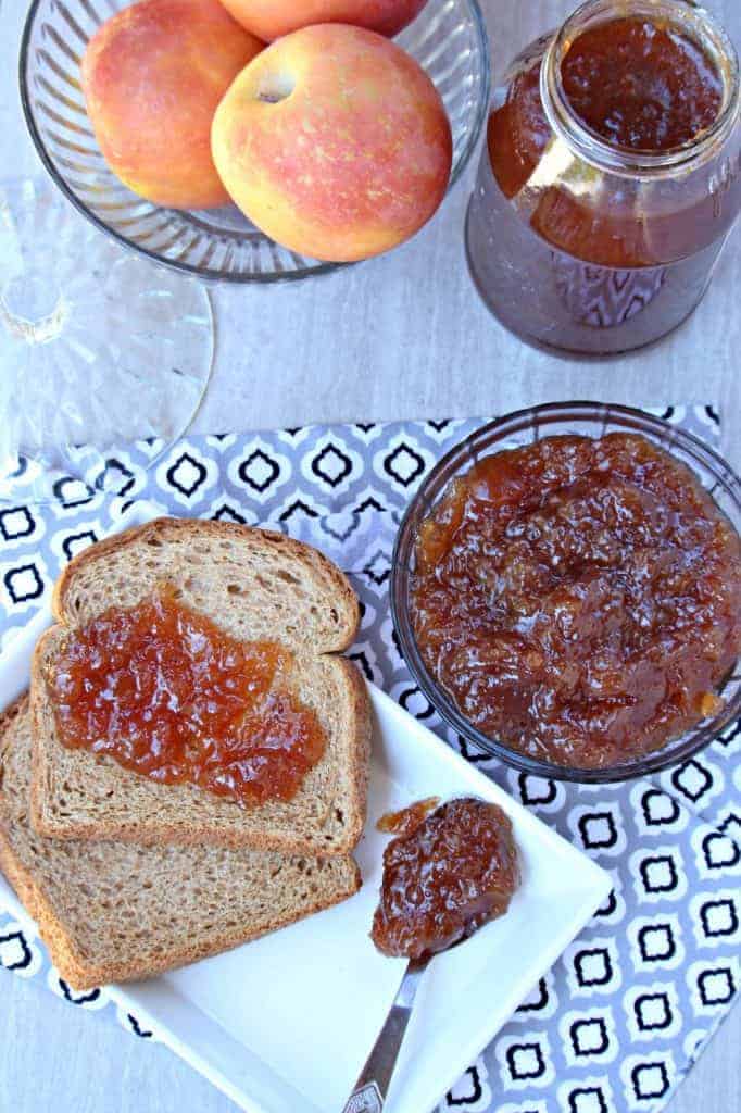 Spiced Apple Jam smeared on bread with more in a bowl in the side