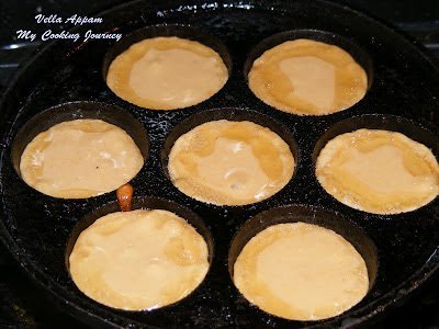 pouring Sweet Appam batter in each hole