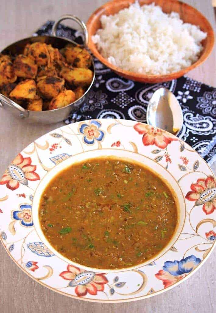 Khatta Meeta Moong Dhal in a white bowl with sides