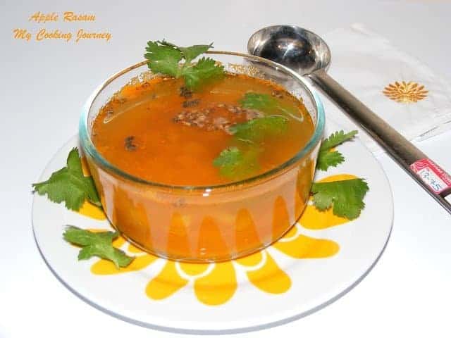 Apple Rasam served in a bowl with spoon