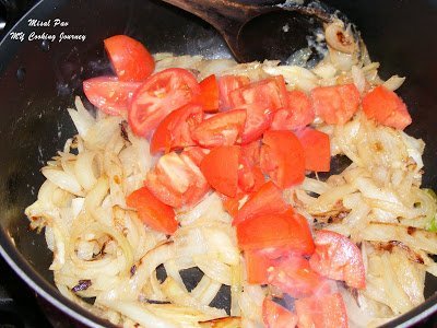 Cooking onion and tomato.