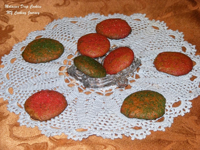 Molasses drop cookies in a glass bowl on a cloth