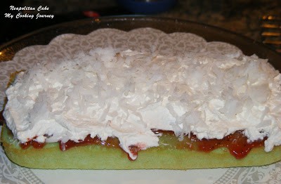 Applying cream on green cake