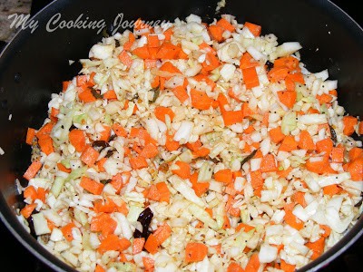 Cooking carrot and cabbage in a pan