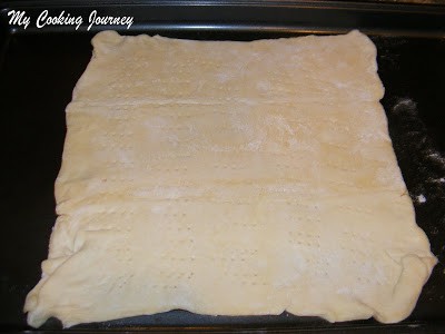 Puff pastry sheet on baking sheet.