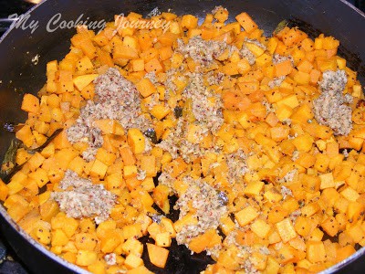 Adding cooked vegetables in a pan.