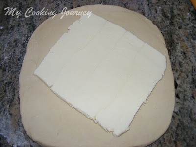 laying the butter on the croissant dough