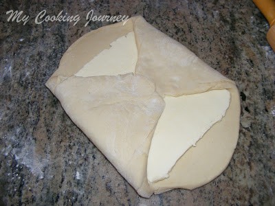 folding the dough with butter inside