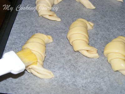 Brushing the croissant with egg wash