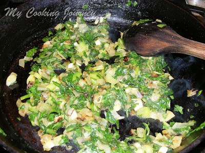 Adding spinach in a the pan and frying
