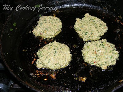 Frying the greens burger.