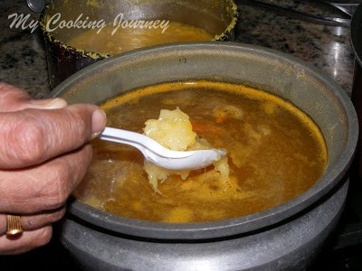 adding pineapple pulp to the boiling rasam