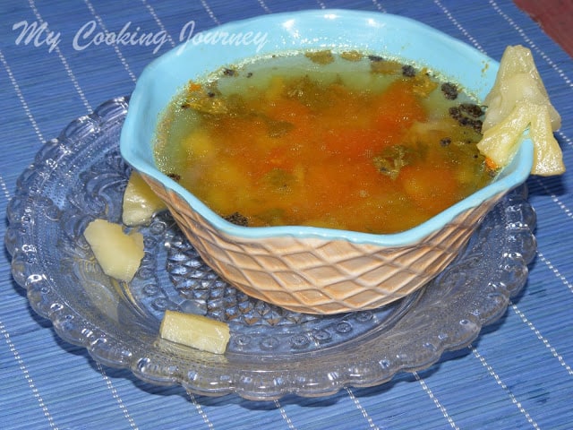 Pineapple rasam served in a dish with bowl