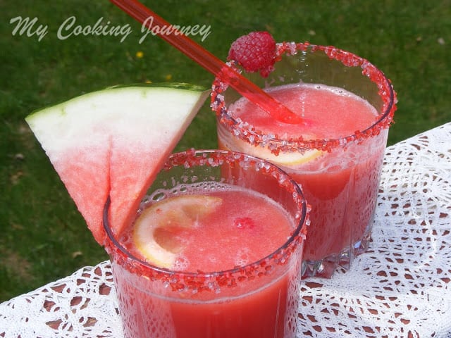 Watermelon Raspberry Lemonade in two glasses with a water melon wedged