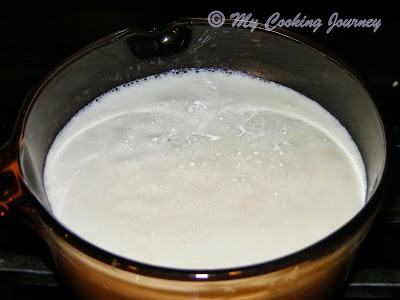 Boiling milk and cream in a pot.