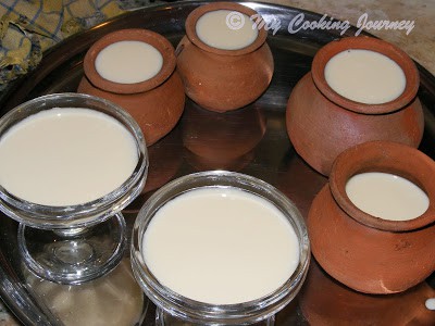 Mishti Doi setting in mud pots and serving bowls.