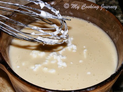 Whisking the milk.