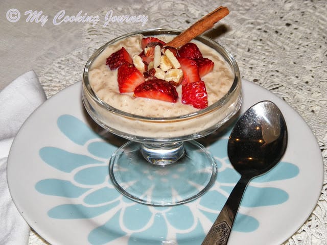 Creamy rice pudding in a bowl with spoon on side