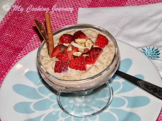 Creamy rice pudding with strawberry and toasted nuts