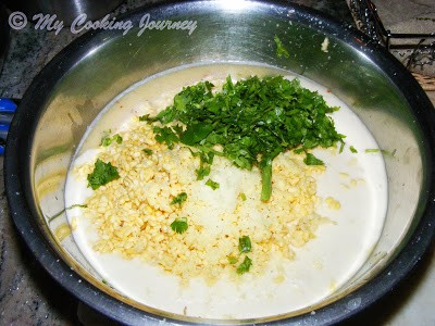 Adding coriander and salt in the batter.