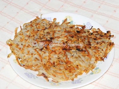 Hash browns ready to serve with ketchup.