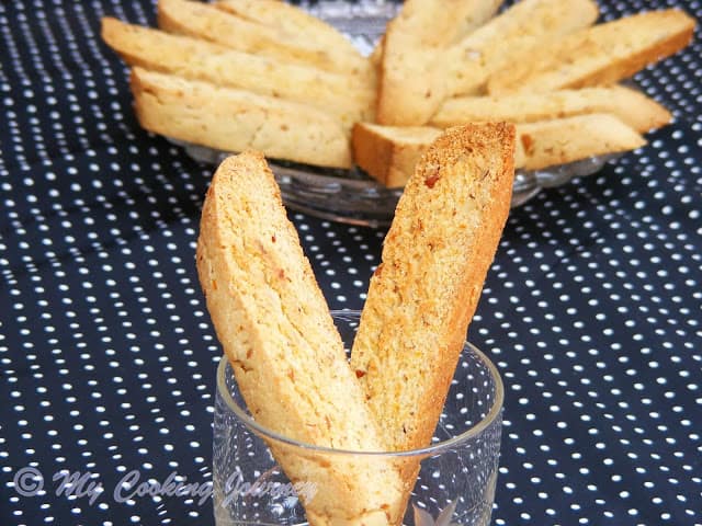 Biscotti  in a glass cup and a plate.