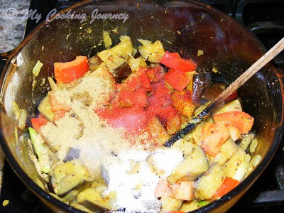 Adding tomatoes and spices