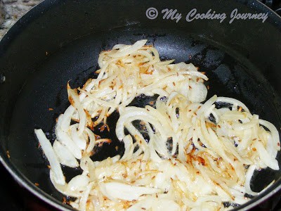 Frying sliced onion.