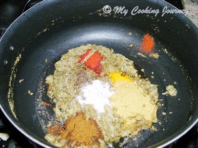 Adding spices in the pan.