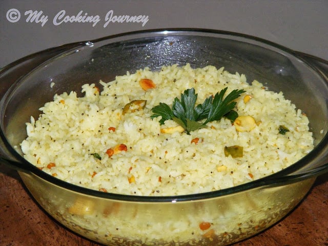 Lemon rice in a glass bowl with garnish