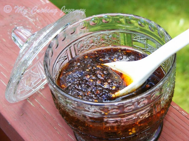 Vegetarian Chili Paste in a glass container with white spoon