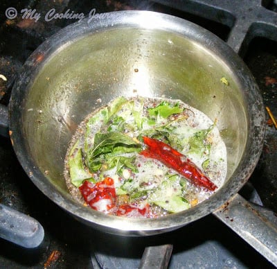 Seasoning the ingredients for Cucumber Stew in a pan