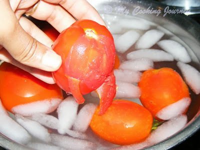 peeling the skin off the tomatoes in a ice bath