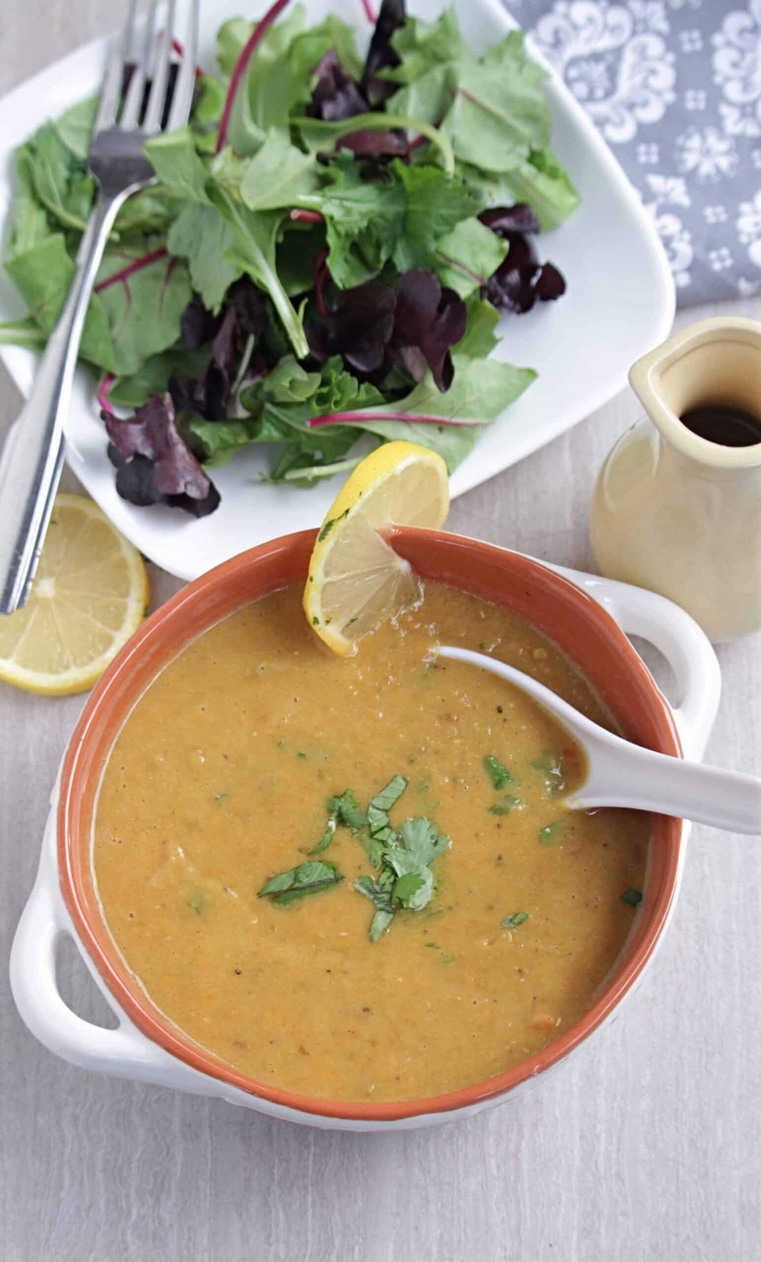 lentil soup with salad in the background