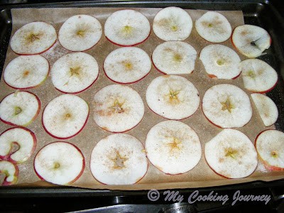 sliced apples arranged in a baking tray