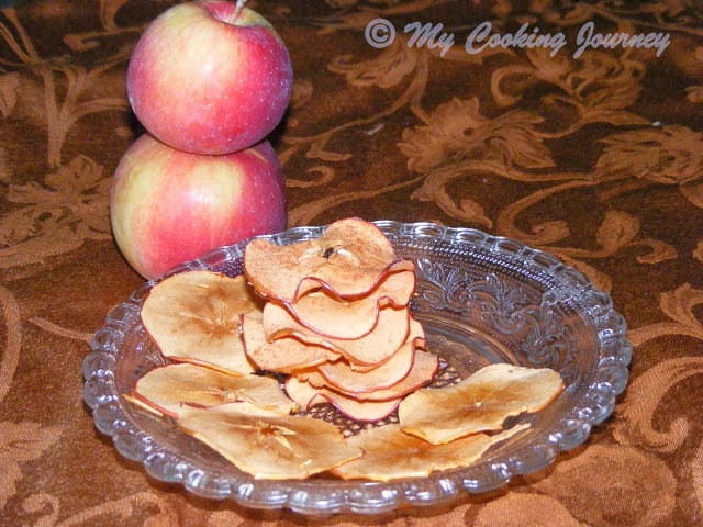 Baked Apple Chips with 2 apples stacked in the background