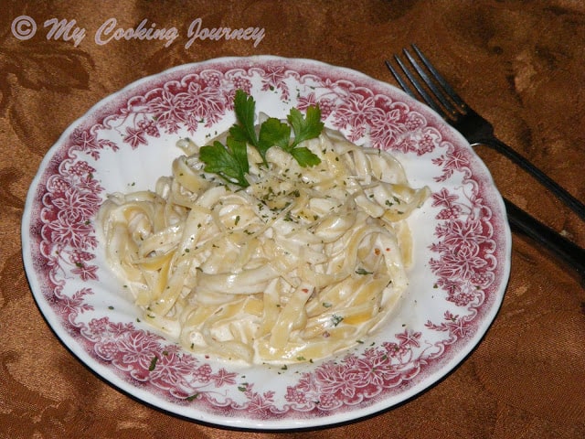 Fettucine Alfredo in a plate with spatula