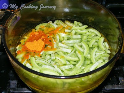 Snake gourd with turmeric and water in a bowl