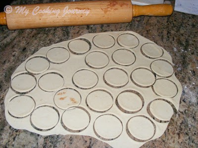 Cutting the dough with small round cookie cutter