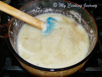 Adding jaggery and cooking the Thengai Arisi Payasam