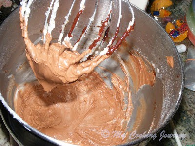 Making batter in a bowl with the help of stand mixer.