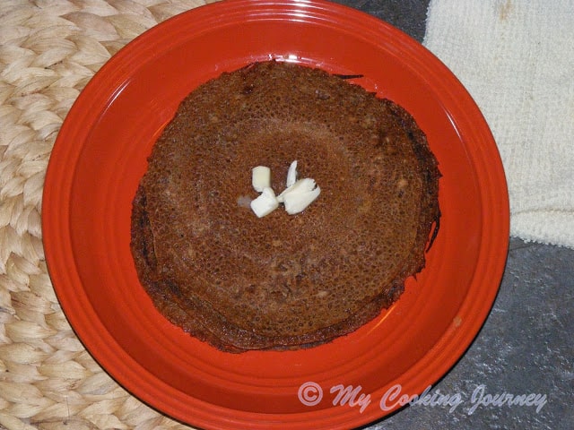 Instant Vellam Dosai in a plate with butter on top