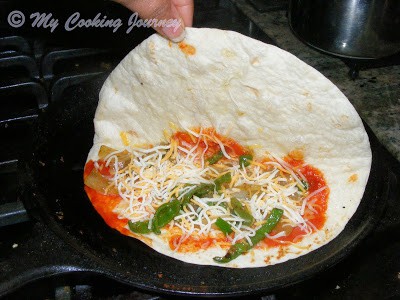 Adding cheese over tortilla