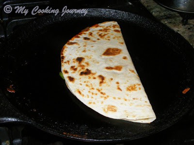 Cooking the pizzadilla on a tawa