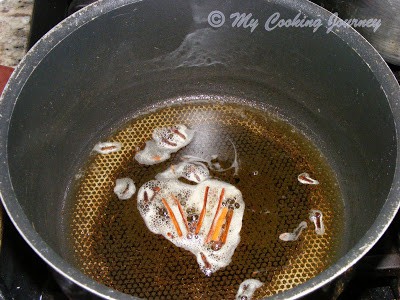 Frying spices in oil.