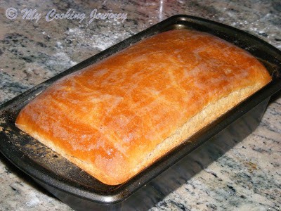 Brushing the melted butter on bread