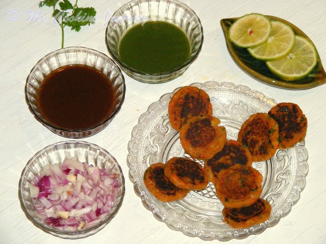 Aloo Tikki served in a dish with Sauces.