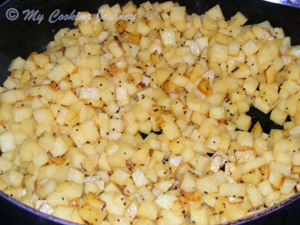 Frying the chopped potato in a pan